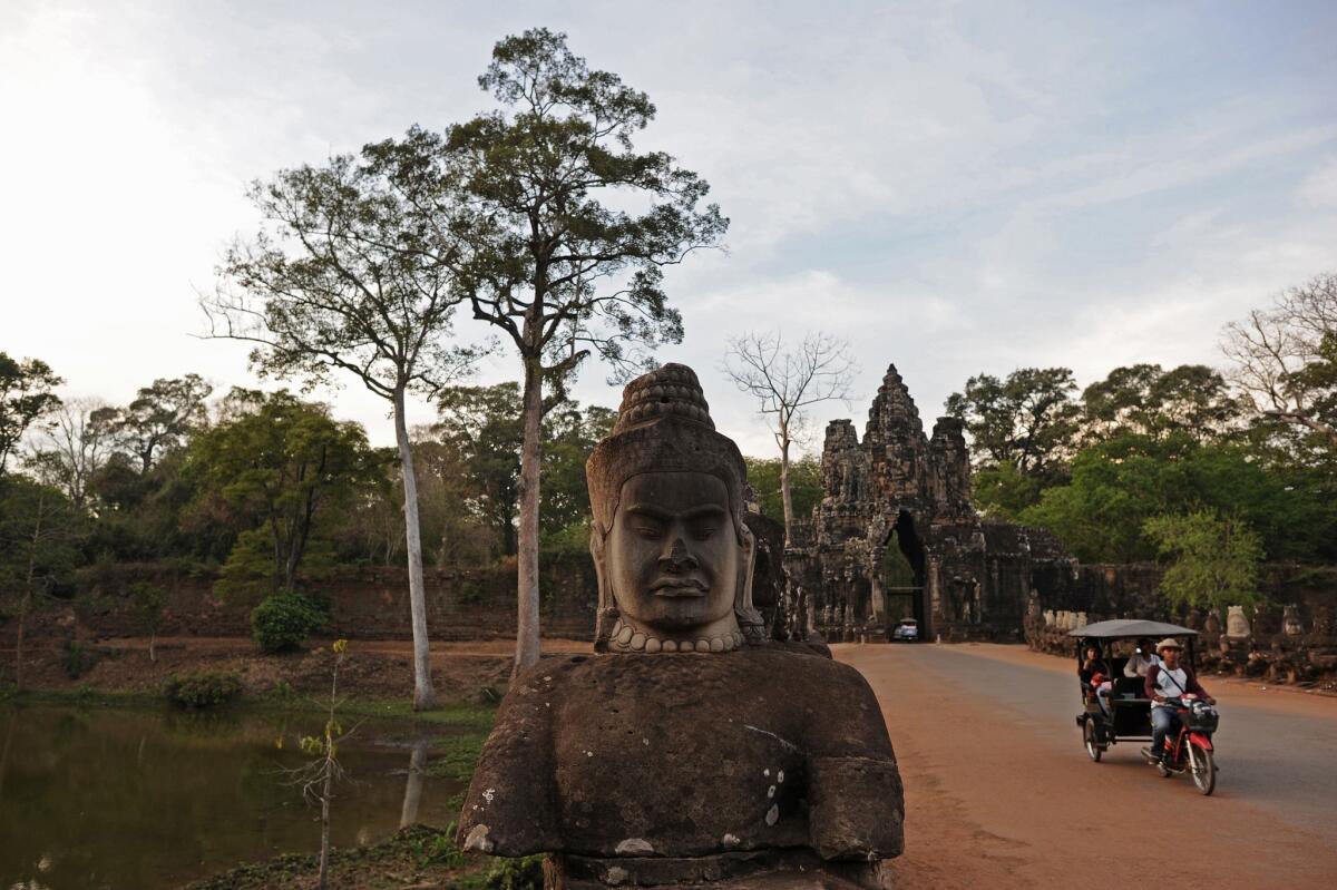 A tuk-tuk bicycle cab takes tourists around Cambodia's ancient city of Angkor Thom, part of the Angkor architectural complex that Google Maps has digitally mapped for the first time and made available online through its World Wonders Project.