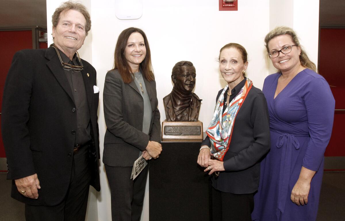 From left, John Wayne's son Patrick Wayne, John Wayne's granddaughter Maria King, King's mother and daughter-in-law (and widow to Michael Wayne) Gretchen Wayne, and granddaughter Josie Wayne attended the dedication ceremony for the Glendale High School John Wayne Performing Arts Center in Glendale on Friday, March 28, 2014.