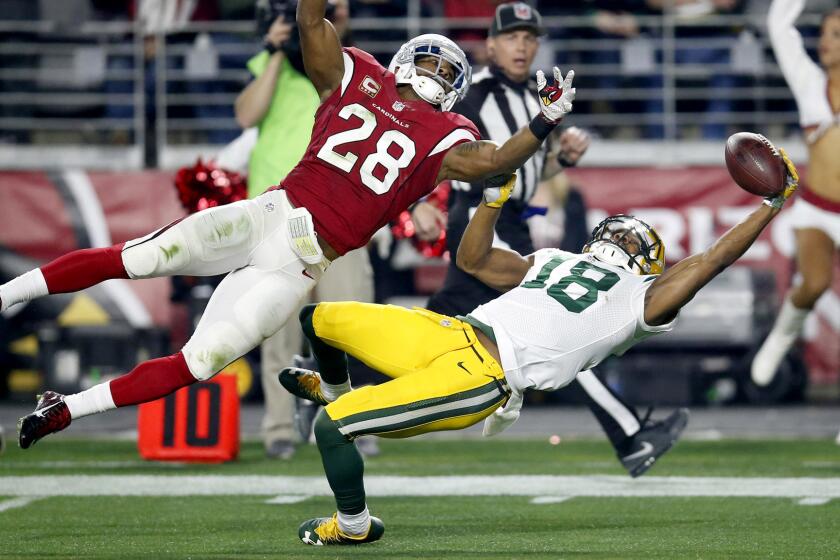Packers wide receiver Randall Cobb (18) makes a one-handed catch against Cardinals cornerback Justin Bethel, on Saturday although the play was nullified by a penalty.