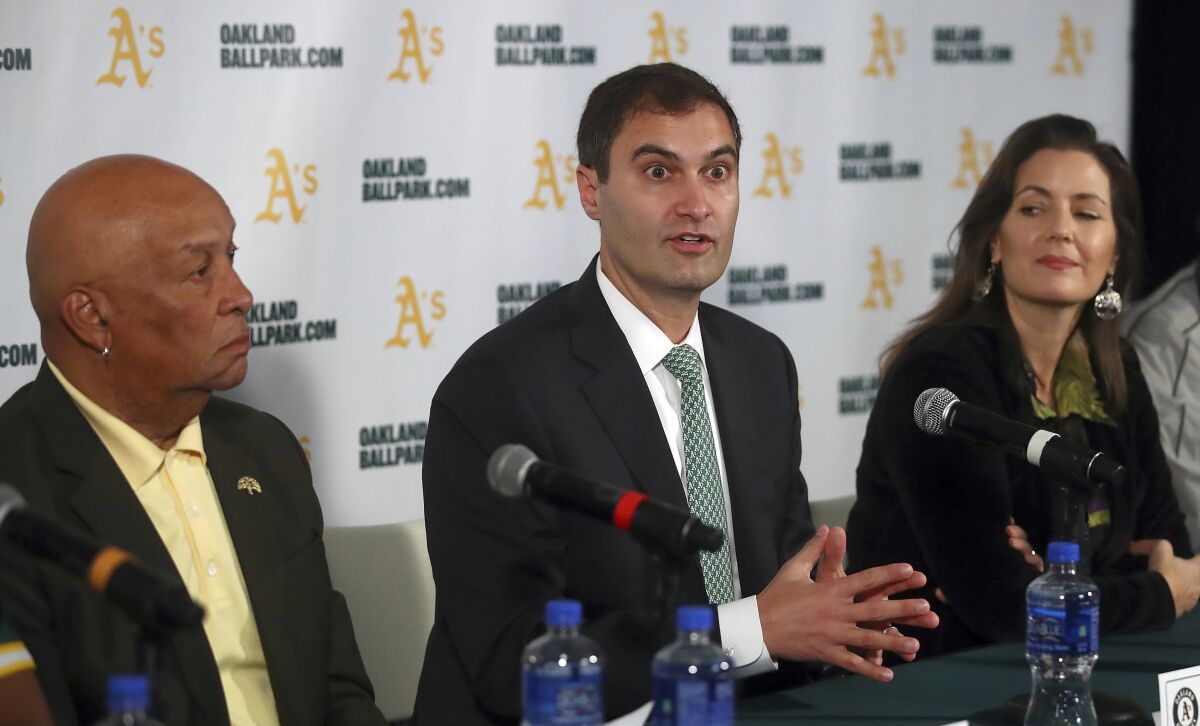 Oakland Athletics President Dave Kaval, center, speaks at a news conference