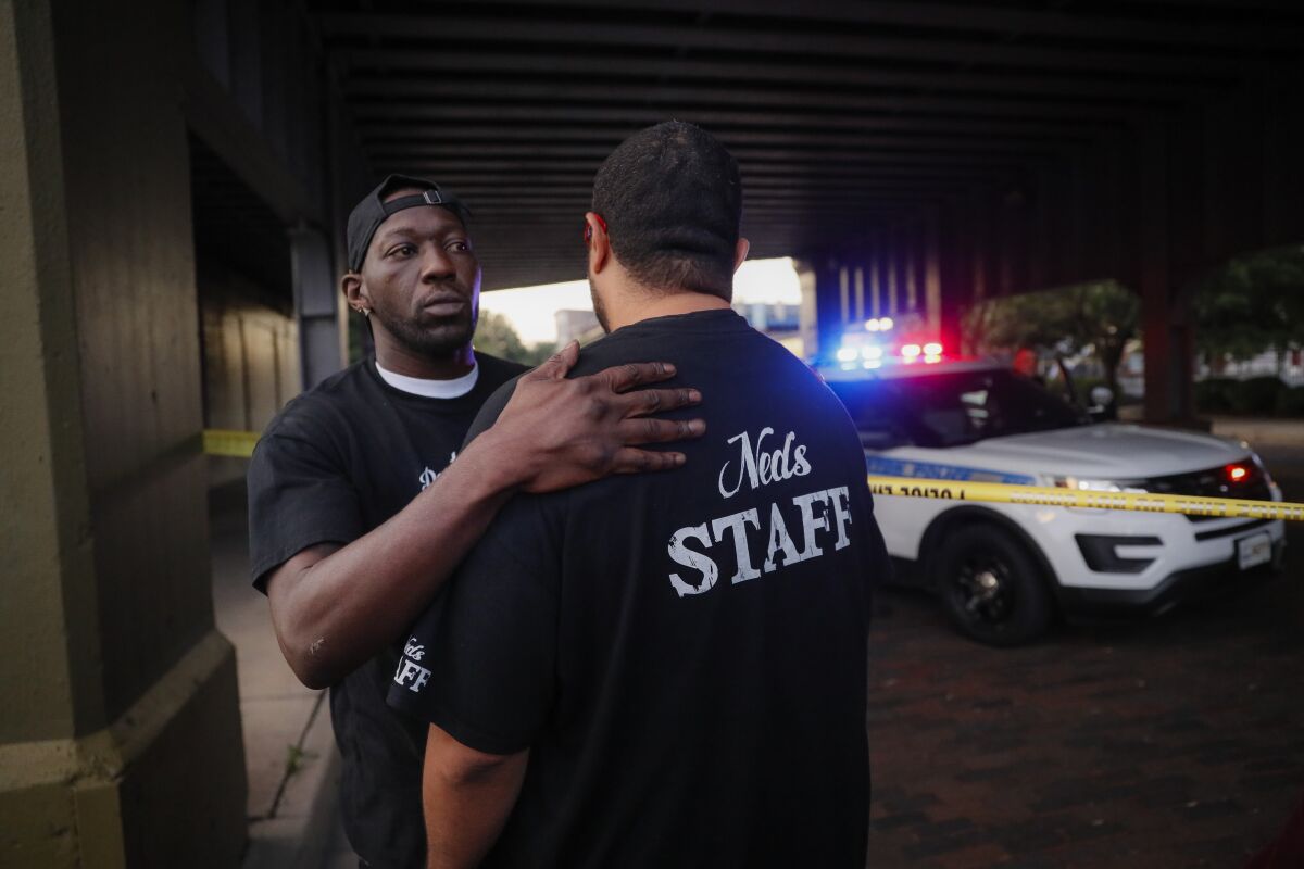Witnesses comfort one another at the scene of a mass shooting in Dayton, Ohio. It was the second mass shooting in the U.S. in less than 24 hours.