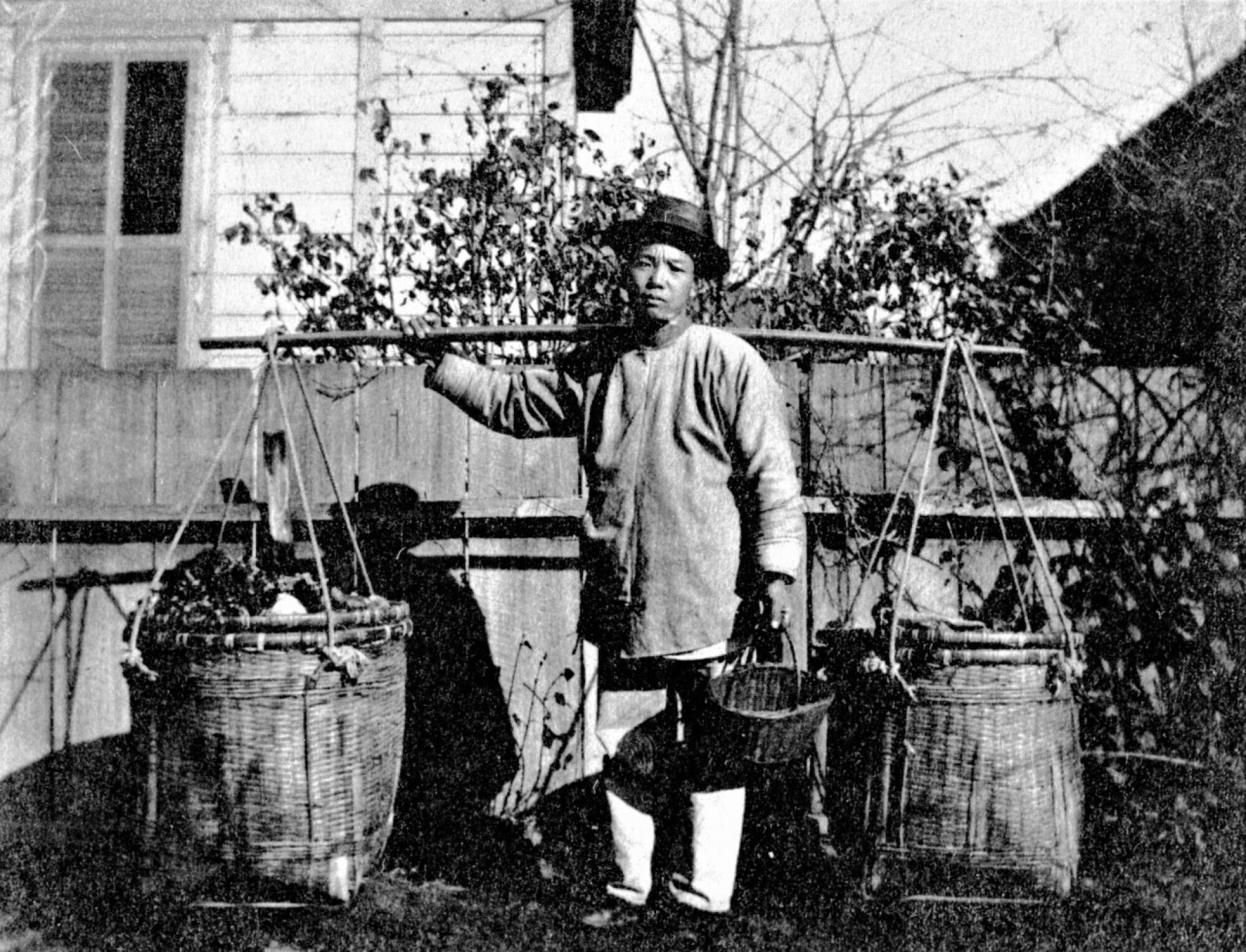 A Chinese vegetable merchant carries his goods in Eureka before the Chinese expulsion in 1885.