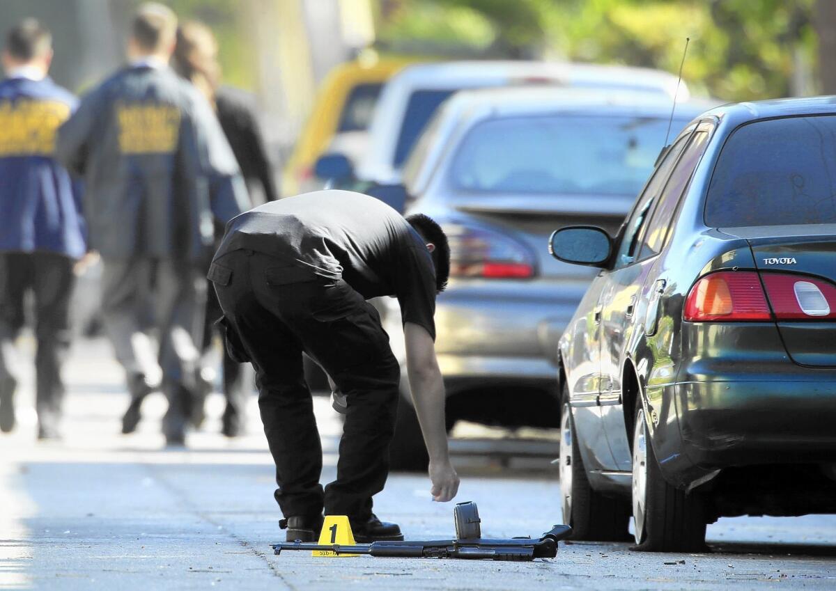 LAPD officers examine evidence after a shooting.
