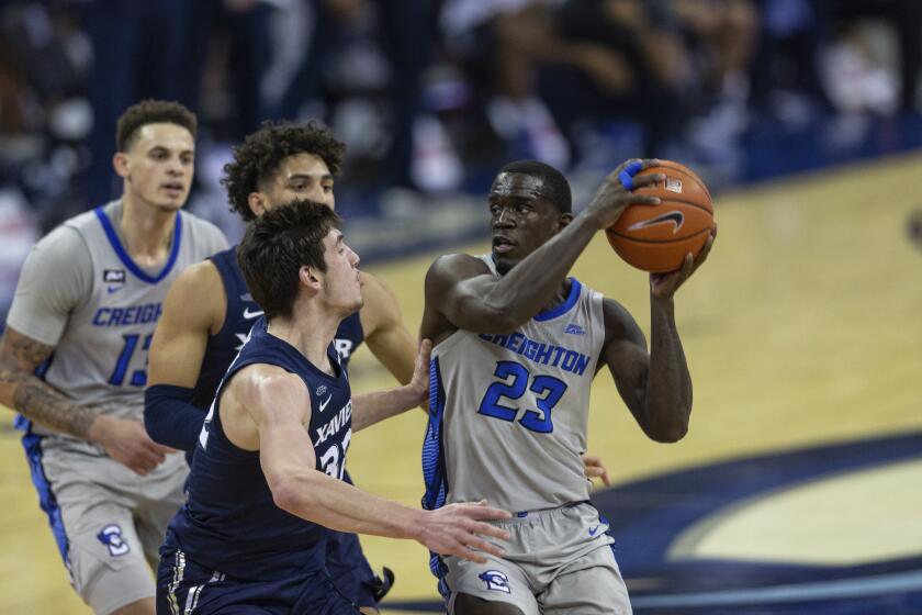 Creighton forward Damien Jefferson (23) drives to the basket against Xavier forward Zach Freemantle (32) in the second half during an NCAA college basketball game on Wednesday, Dec. 23, 2020, in Omaha, Neb. (AP Photo/John Peterson)