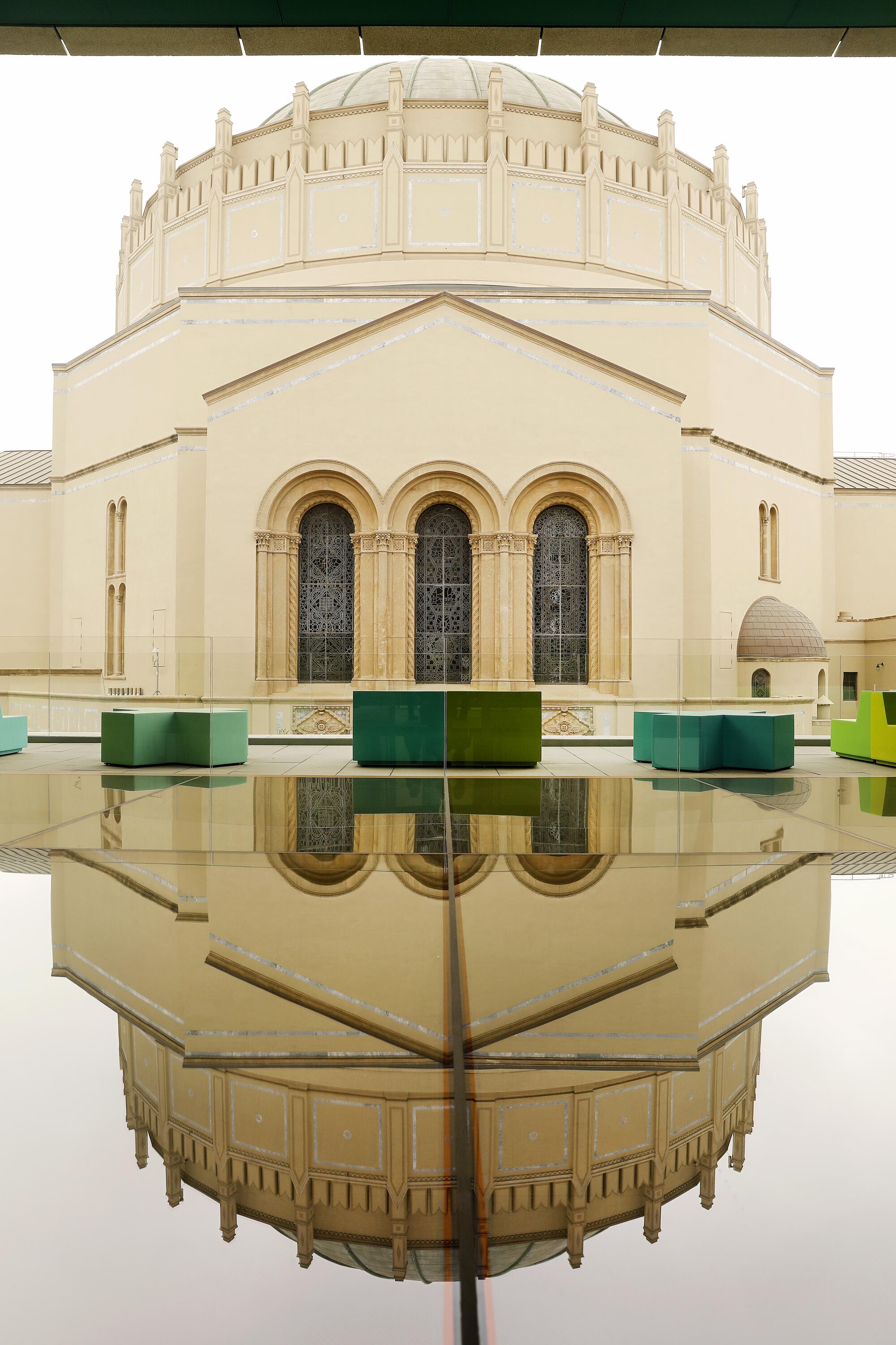 A Byzantine-style dome is reflected in a glass skylight