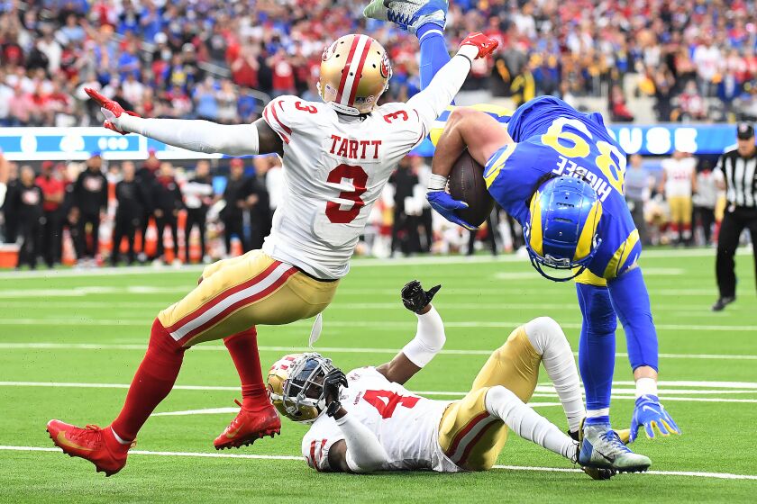 Inglewood, California January 30, 2022: Rams receiver Tyler igbee is upended by 49ers cornerback Emmanuel Moseley (4) and Jaquiski after a catch in the first quarter at SoFi Stadium in Inglewood Sunday. (Wally Skalij/Los Angeles Times)