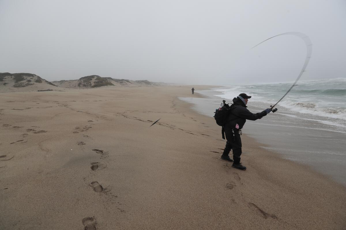 A Marina resident fishes on a foggy morning