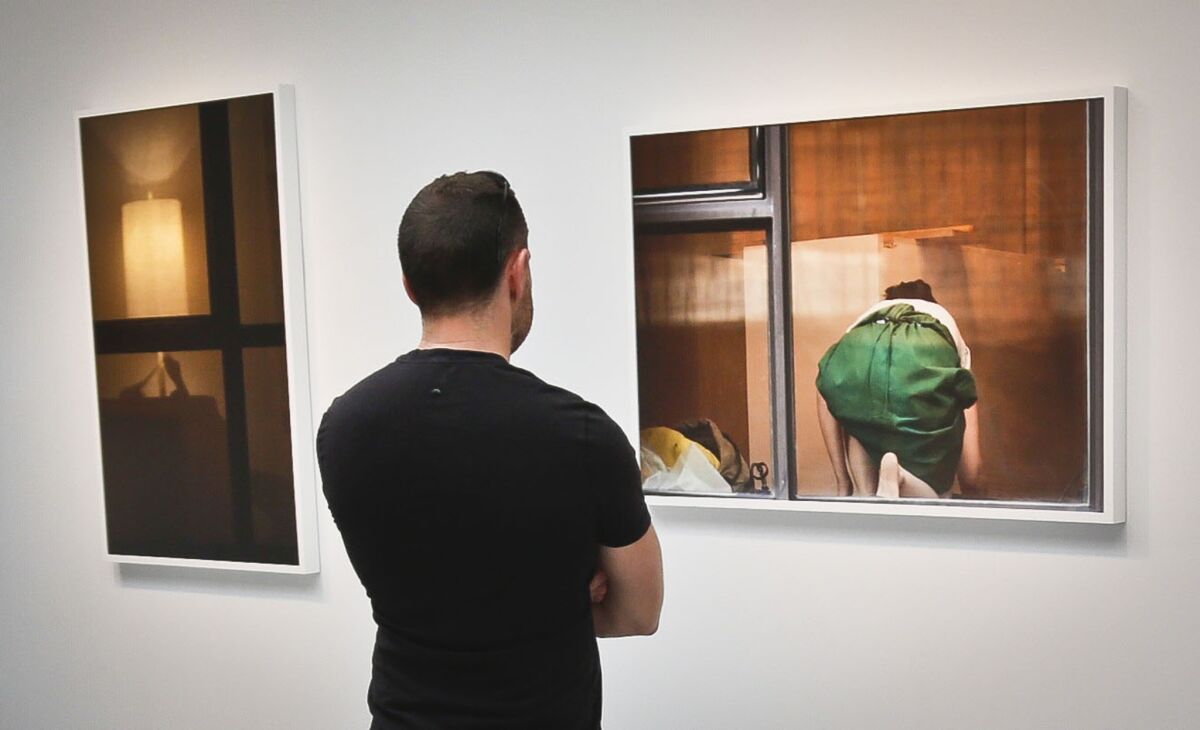 A visitor views the photography of Arne Svenson on Thursday at the Julie Saul Gallery in New York.