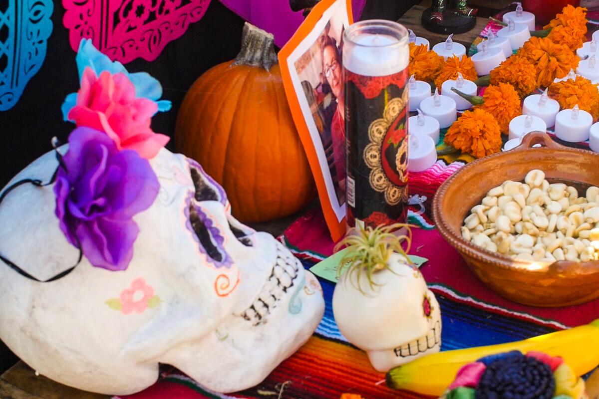 Sugar skulls, food and candles are offerings to honor a loved one on a Day of the Dead altar. 