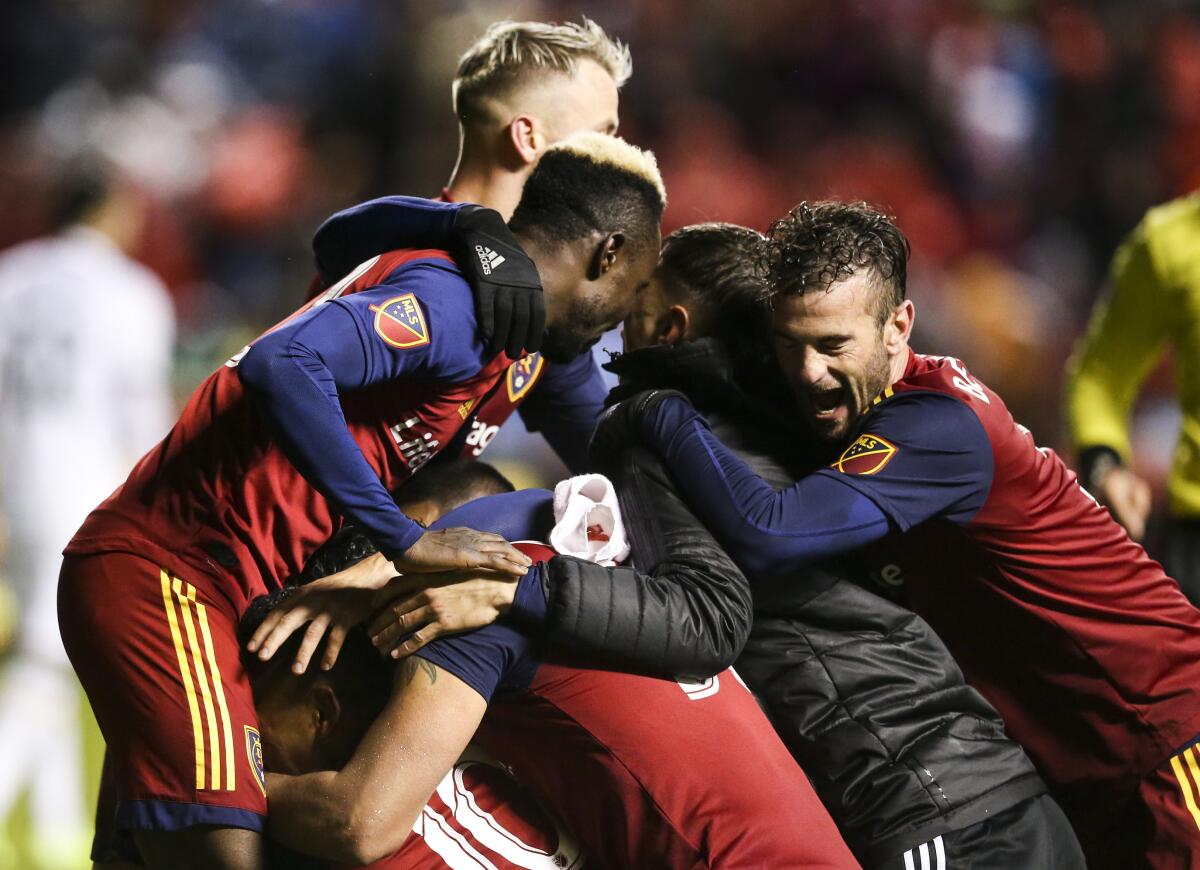 Real Salt Lake piles on top of Jefferson Savarino after his goal during the second half against the Portland Timbers in an MLS soccer Western Conference first-round playoff match in Sandy, Utah, Saturday, Oct. 19, 2019. (Colter Peterson/The Deseret News via AP)