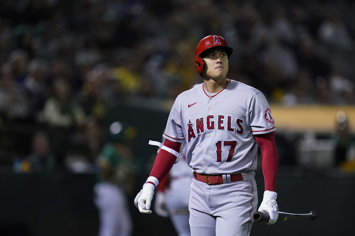 Los Angeles Angels' Shohei Ohtani walks to the dugout after striking out against the Oakland Athletics during the eighth inning of a baseball game in Oakland, Calif., Tuesday, Oct. 4, 2022. (AP Photo/Godofredo A. Vásquez)