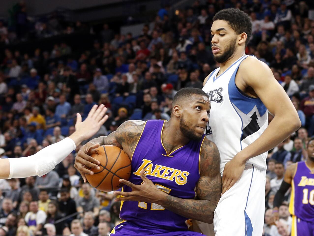 Lakers' Thomas Robinson, left, drives on Minnesota Timberwolves' Karl-Anthony Towns during the second half.