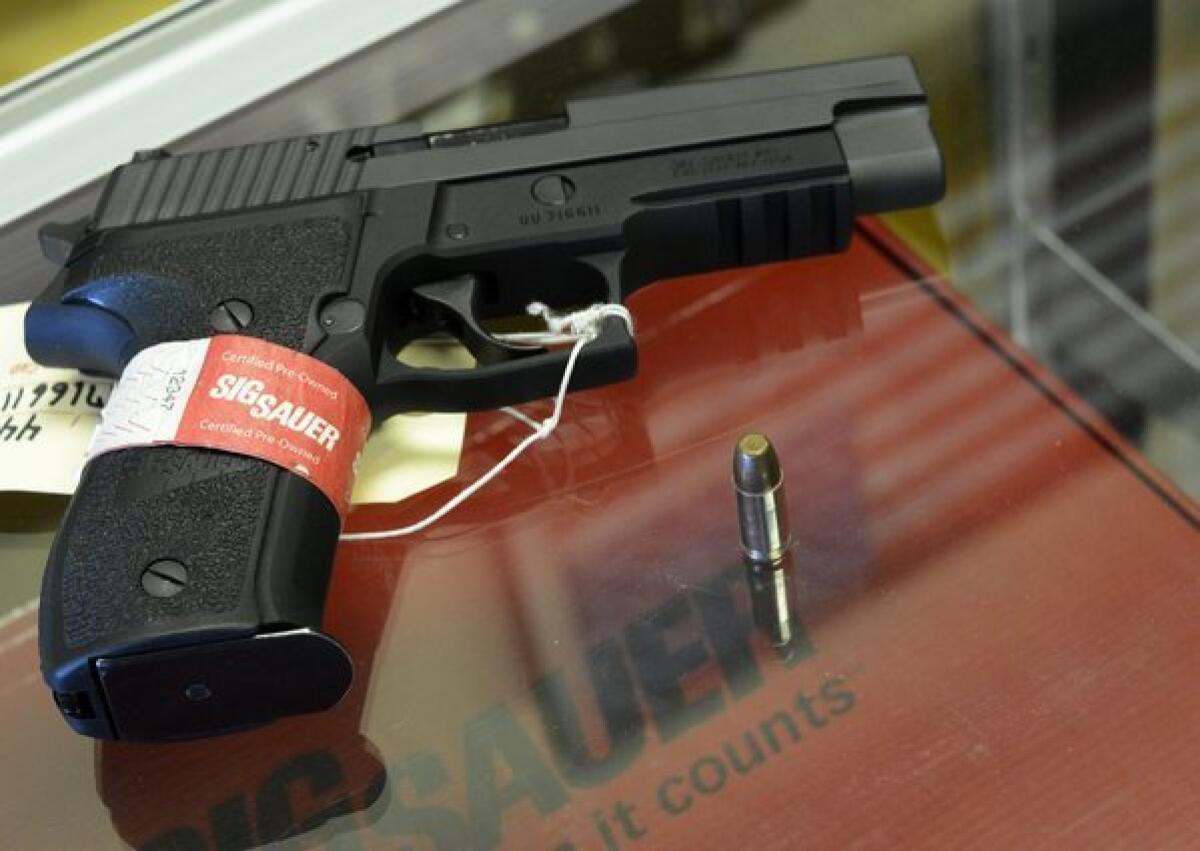 A Sig Sauer handgun is seen at CJI Guns store in Tucker, Ga.
