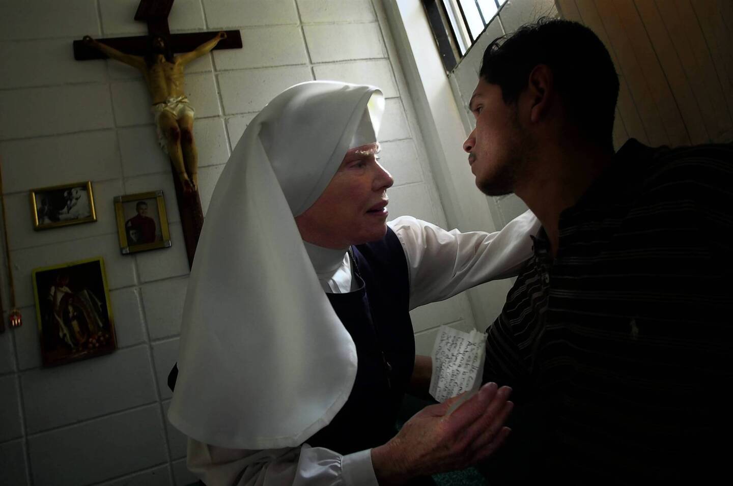 In this photo from 2002, Sister Antonia Brenner consoles inmate Jorge Villalobos inside her converted cell at the notorious La Mesa penitentiary in Tijuana. Brenner died Thursday at the age of 86.