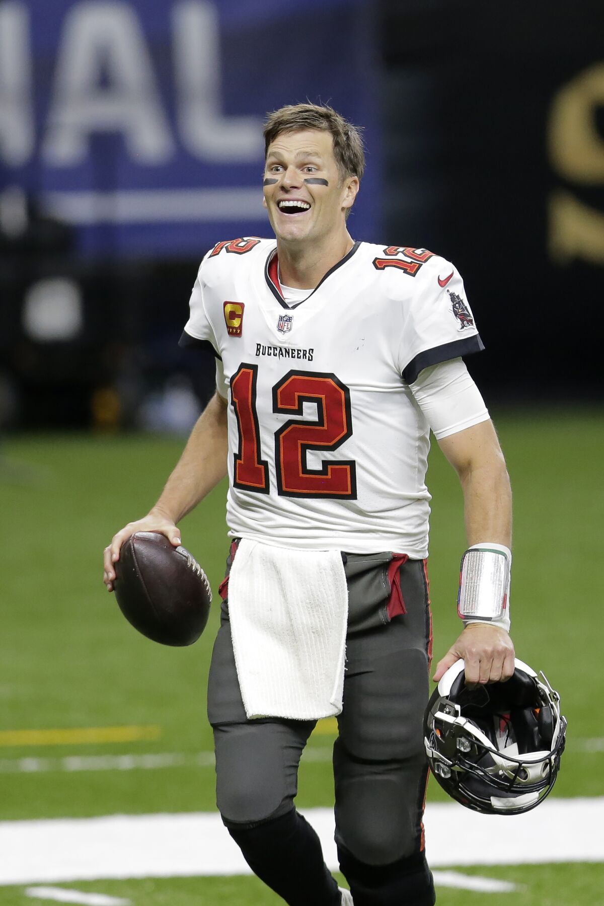 FILE - Tampa Bay Buccaneers quarterback Tom Brady smiles after an NFL divisional round playoff football game against the New Orleans Saints in New Orleans, in this Sunday, Jan. 17, 2021, file photo. The Buccaneers won 30-20. Reporters who covered Tom Brady for two decades in New England rarely expected anything enlightening or entertaining to emerge from the quarterback’s mouth. Keep to the straight and narrow, reveal nothing about yourself or your team, and just win. So when Brady began cracking wise as a Tampa Bay quarterback and, once again, as a Super Bowl MVP, people took notice. (AP Photo/Brett Duke, File)