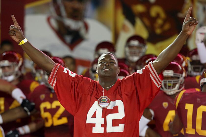 LOS ANGELES, CALIF. - OCT 10, 2013.Former USC player Keyshawn Johnson leads the Trojan squad out of the tunnel before the game against Arizona on Thursday, Oct. 10, 2013, 2013, at the Coliseum in Los Angeles. (Luis Sinco/Los Angeles Times)