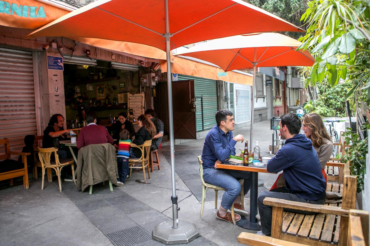 People enjoy outdoor dining at the Mexico City restaurant El Parnita.