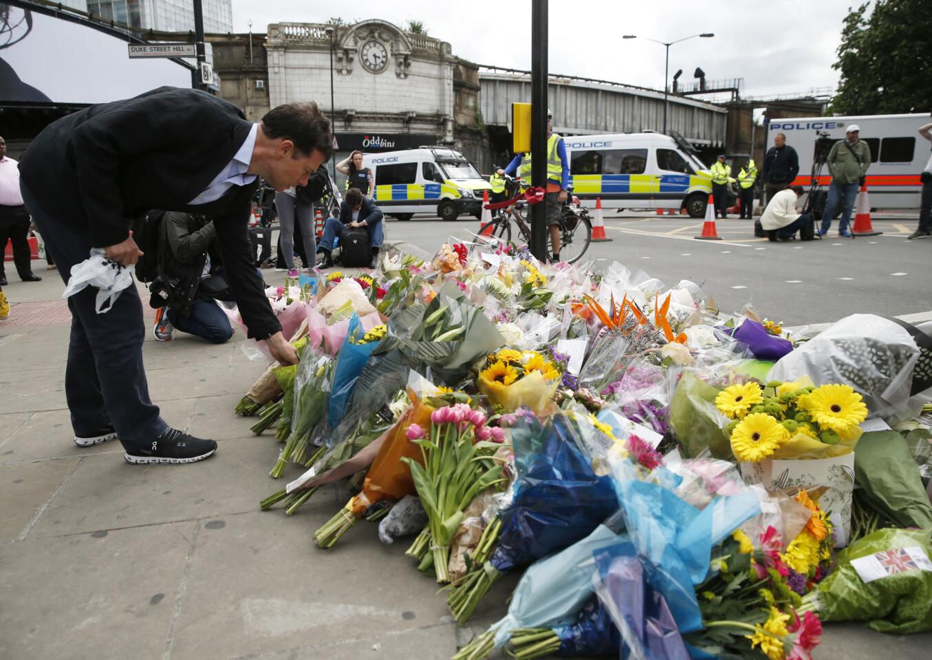 A man leaves flowers at a tribute in the London Bridge area on June 5.