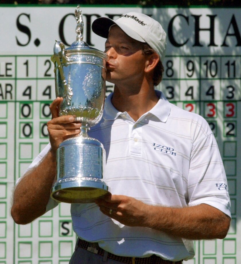 FILE - In this June 18, 2001, file photo, Retief Goosen, of South Africa, kisses the winner's trophy on the 18th green at Southern Hills Country Club after beating Mark Brooks in a 18-hole playoff for the U.S. Open Championship in Tulsa, Okla. Twenty years ago this week, Goosen missed a 2-foot putt and was forced into a playoff. (AP Photo/Dave Martin, File)