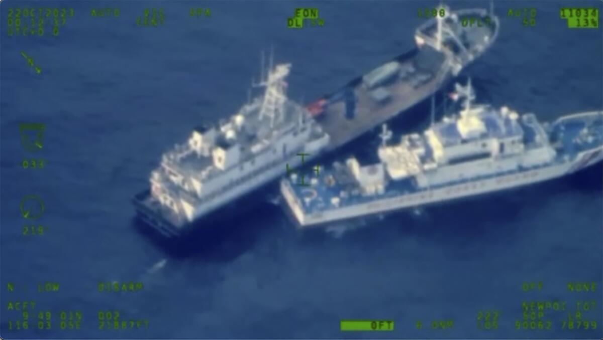 A Chinese militia vessel, top, and Philippine coast guard vessel BRP Cabra colliding