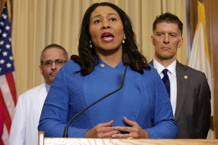 San Francisco Mayor London Breed speaks from behind a podium.
