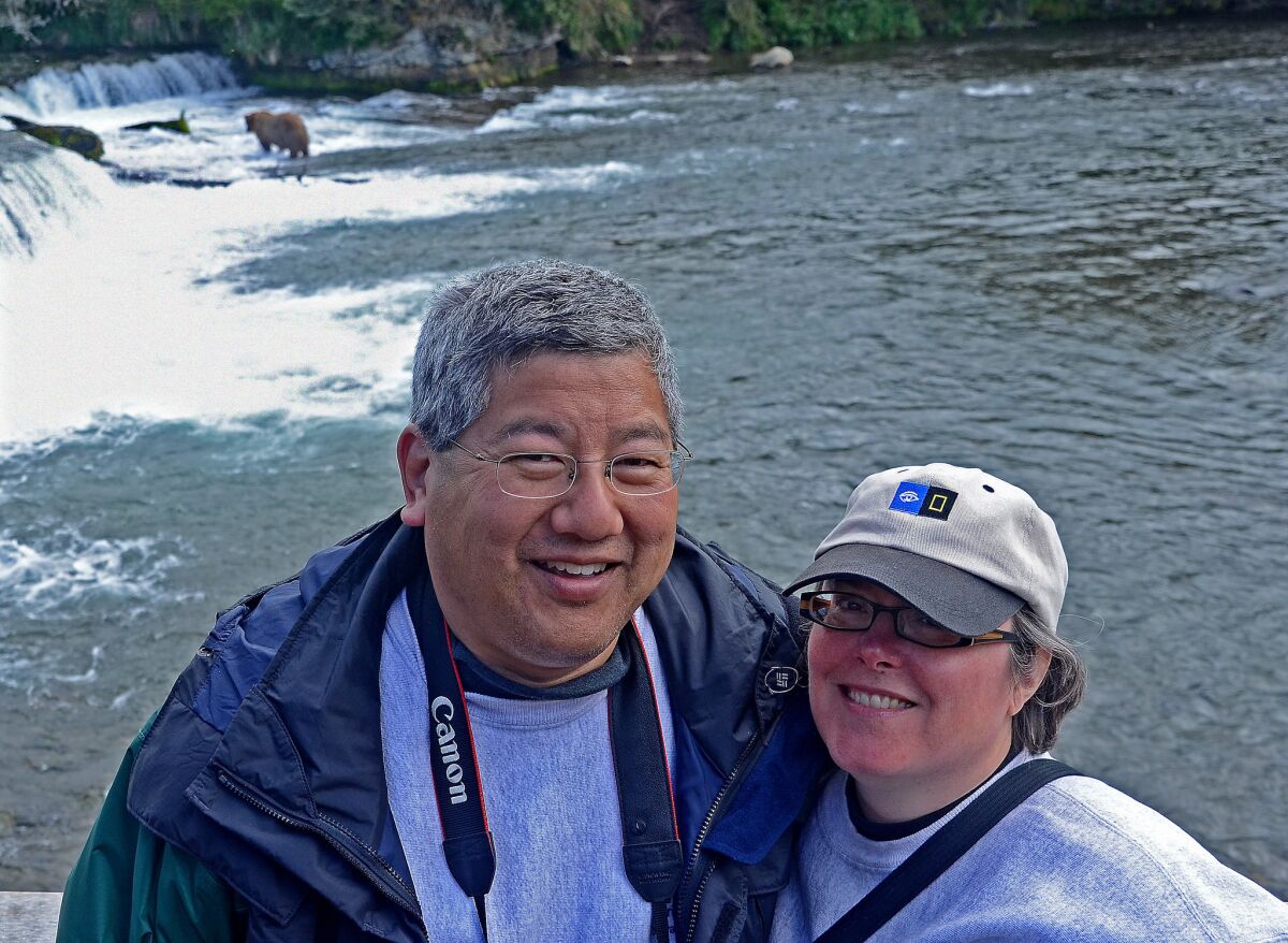Frequent traveler Ruey Tu and his partner, Amy Marta, at Brooks Falls, Alaska.