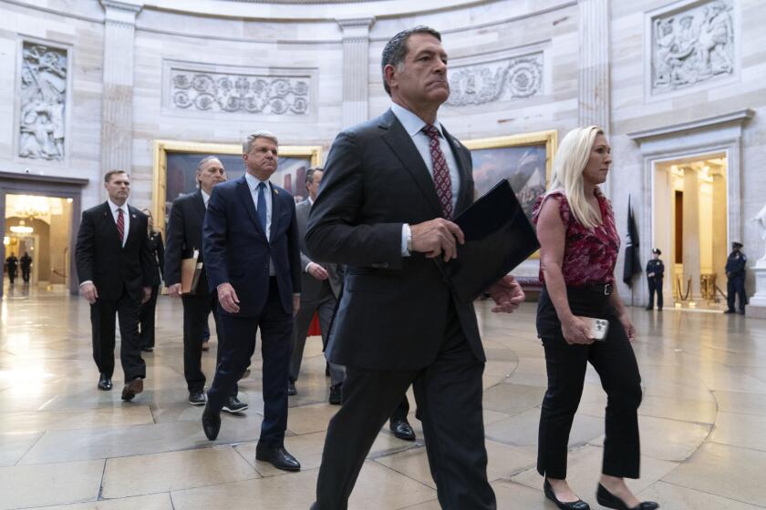 House Impeachment Managers from left, Rep. Michael Guest, R-Miss., Rep. Andy Biggs, R-Ariz., House Foreign Affairs Committee Chairman Michael McCaul, R-Texas, House Committee on Homeland Security Chairman Mark Green, R-Tenn., and Rep. Marjorie Taylor Greene, R-Ga., walk cross the Capitol Rotunda to the Senate chamber to deliver Homeland Security Secretary Alejandro Mayorkas' Impeachment Articles at the Capitol in Washington, Tuesday, April 16, 2024. (AP Photo/Jose Luis Magana)