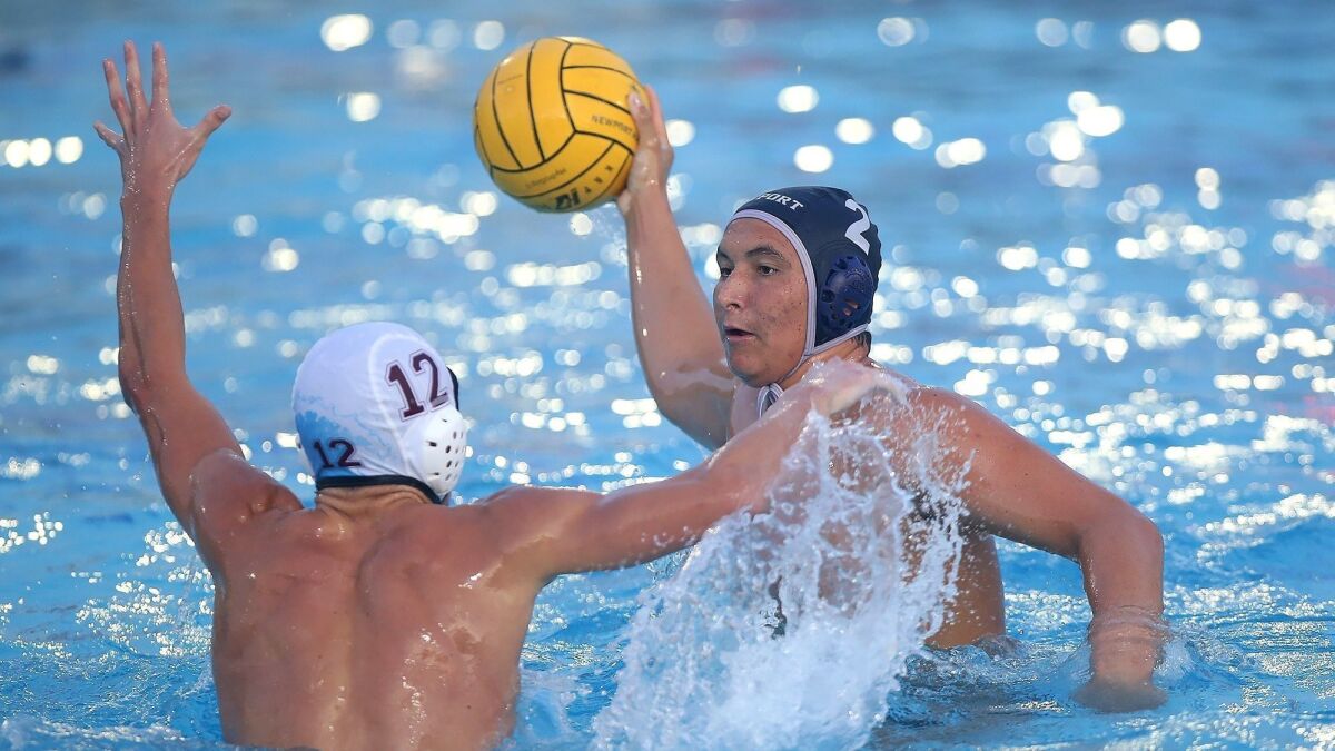 Newport Harbor High's Makoto Kenney looks to shoot as Laguna Beach defender William Clark gets in his way during the opening round of the CIF Southern Section Division 1 playoffs on Thursday.