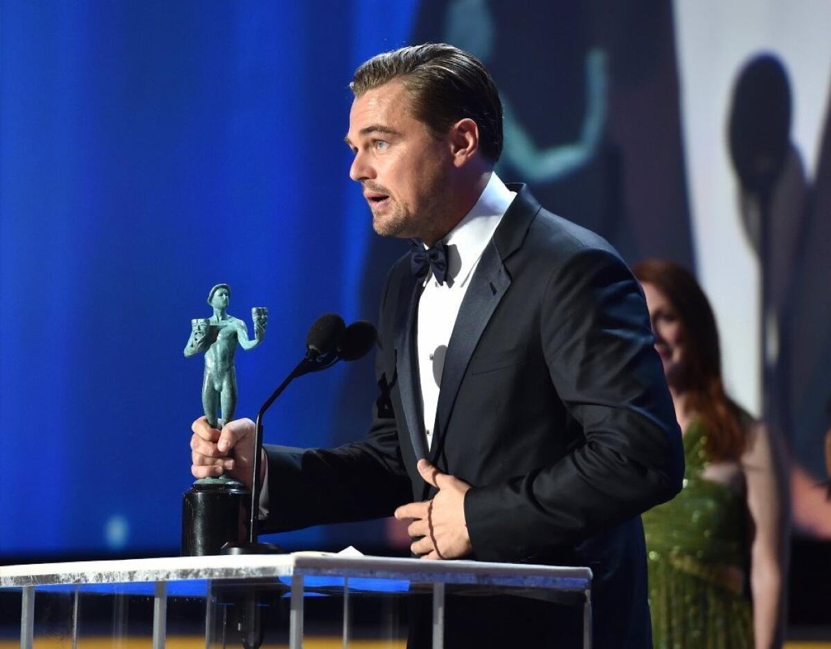 Leonardo DiCaprio accepts the male lead actor award from the Screen Actors Guild on Sunday for "The Revenant."