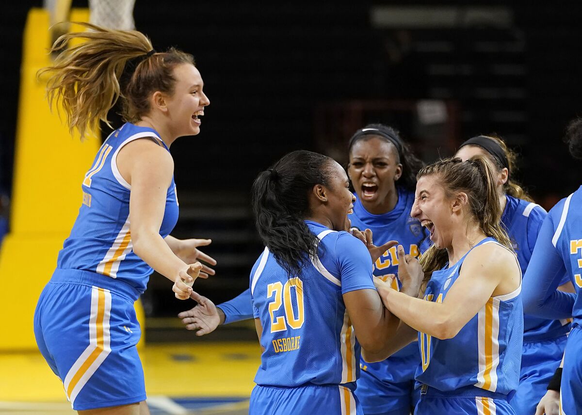 UCLA players Emily Bessoir, Charisma Osborne, Michaela Onyenwere and Chantel Horvat celebrate a win.