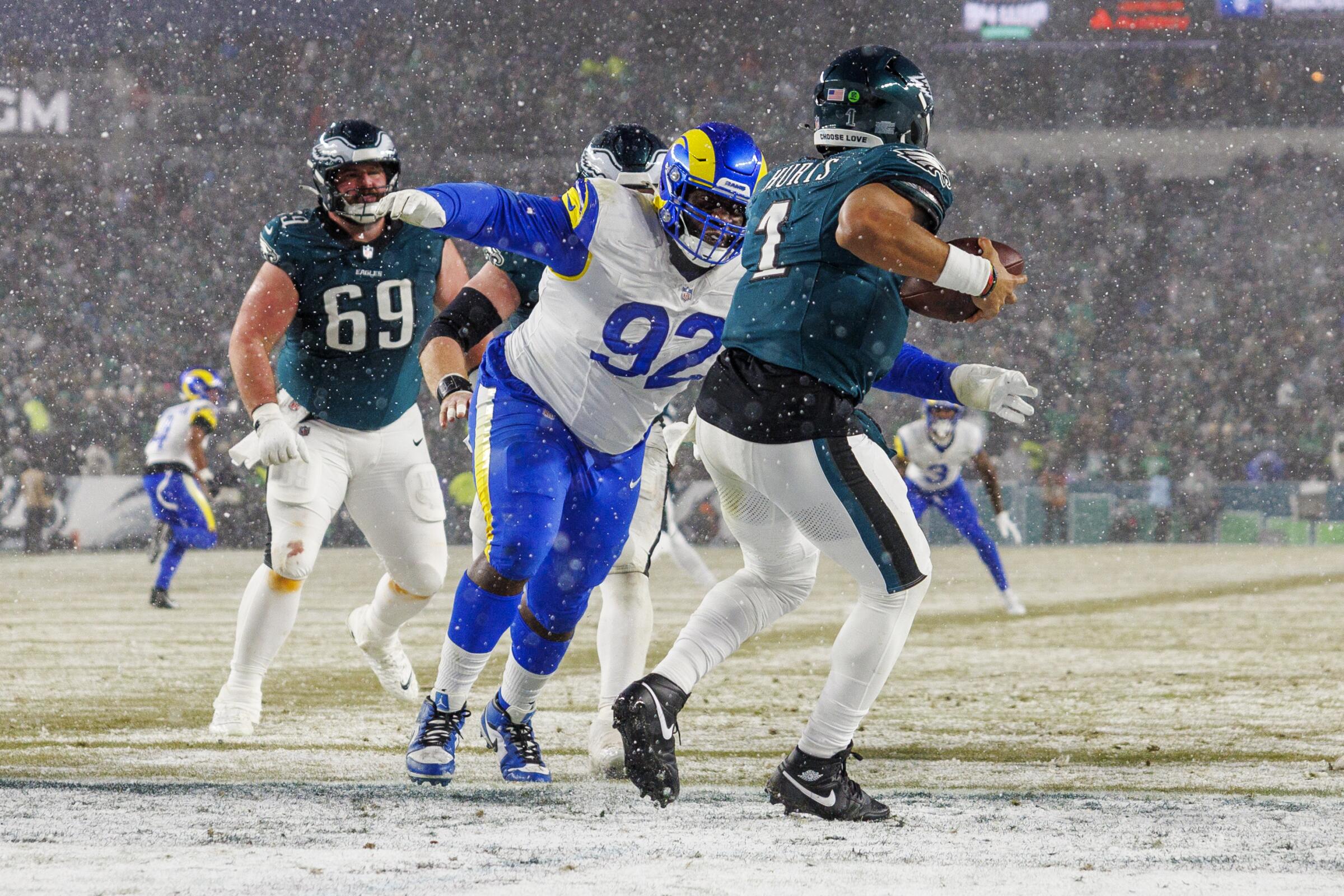 Rams defensive tackle Neville Gallimore closes in to sack Philadelphia Eagles quarterback Jalen Hurts.