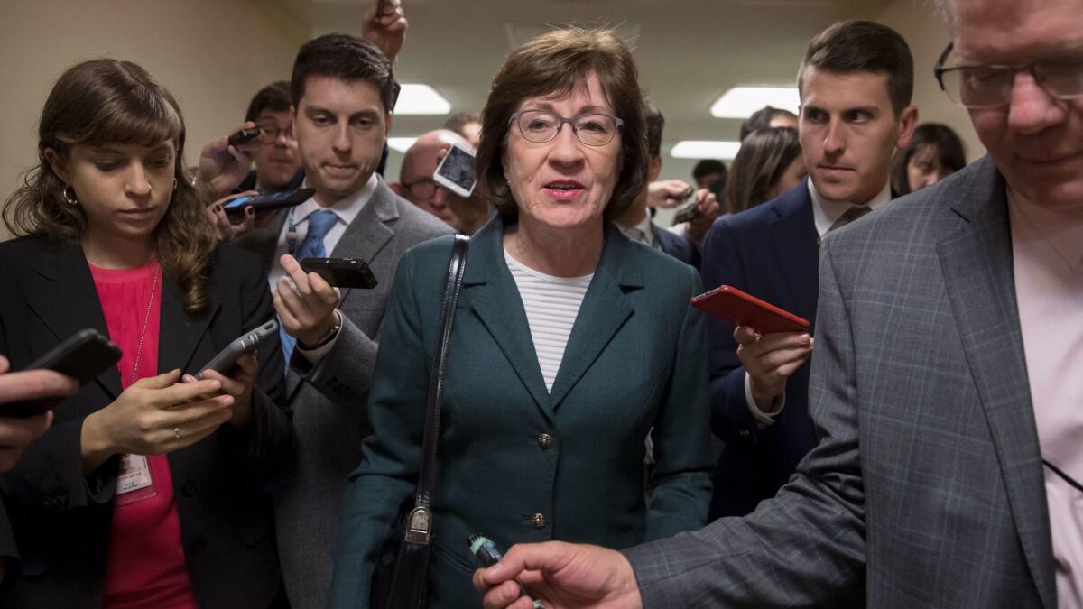 With reporters looking for updates, Sen. Susan Collins, R-Maine, and other senators rush to the chamber to vote.