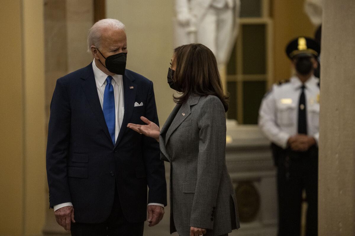 President Biden and Vice President Kamala Harris talk in the Capitol 