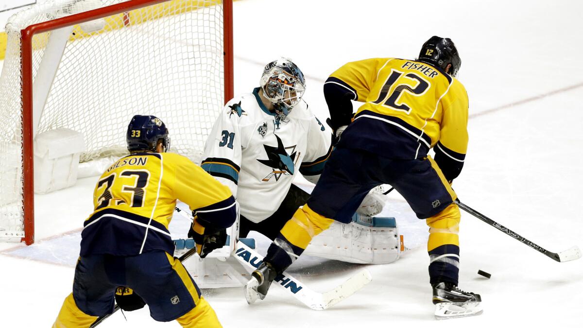 Predators forward Mike Fisher (12) prepares to score the winning goal against Sharks goalie Martin Jones (31) during the third overtime Thursday night.