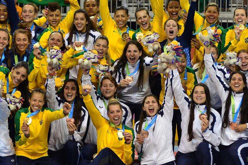 The Brazilian (yellow) and Argentinian teams celebrate their gold and silver respectively following the Women's Gold Medal Handball match Brazil vs. Argentina during the 2015 Pan American Games in Toronto, Canada, July 24, 2015. Brazil won 25-20. AFP PHOTO Eva HAMBACHEVA HAMBACH/AFP/Getty Images ** OUTS - ELSENT, FPG - OUTS * NM, PH, VA if sourced by CT, LA or MoD **