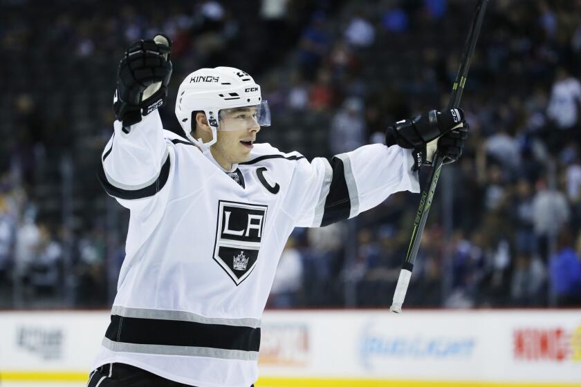 Kings right wing Dustin Brown celebrates after scoring the game-winning shoot out goal against the Avalanche during a preseason game.