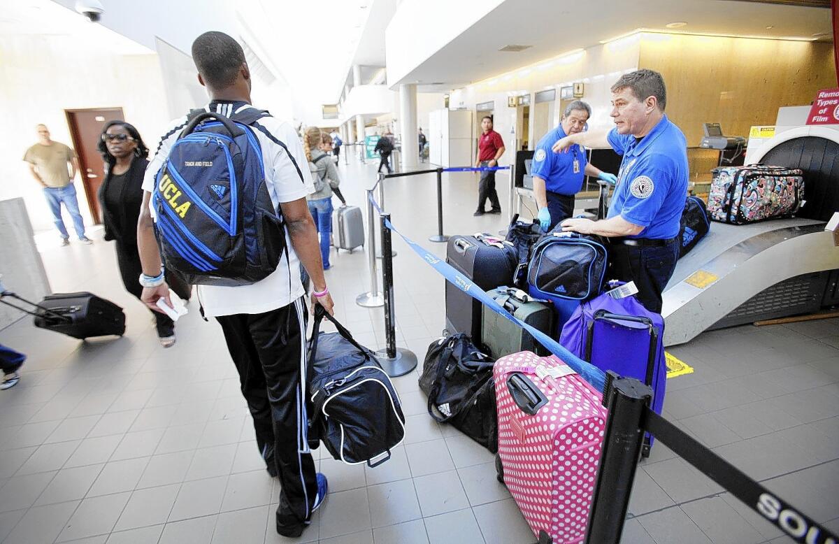 The Transportation Security Administration has worked hard to ease the screening process for frequent travelers to focus more attention on high-risk fliers. Above, TSA workers check baggage at Los Angeles International Aiport.