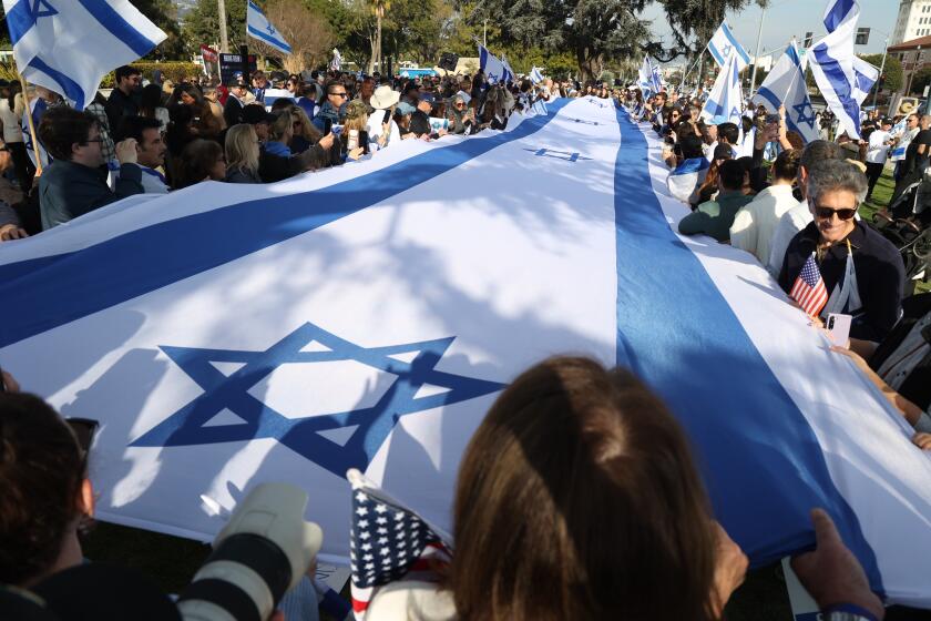 Beverly Hills , CA - January 01: People hold a large Israel flag during a pro Israel protest on Saturday, Jan. 14, 2024 in Beverly Hills, CA. (Michael Blackshire / Los Angeles Times)