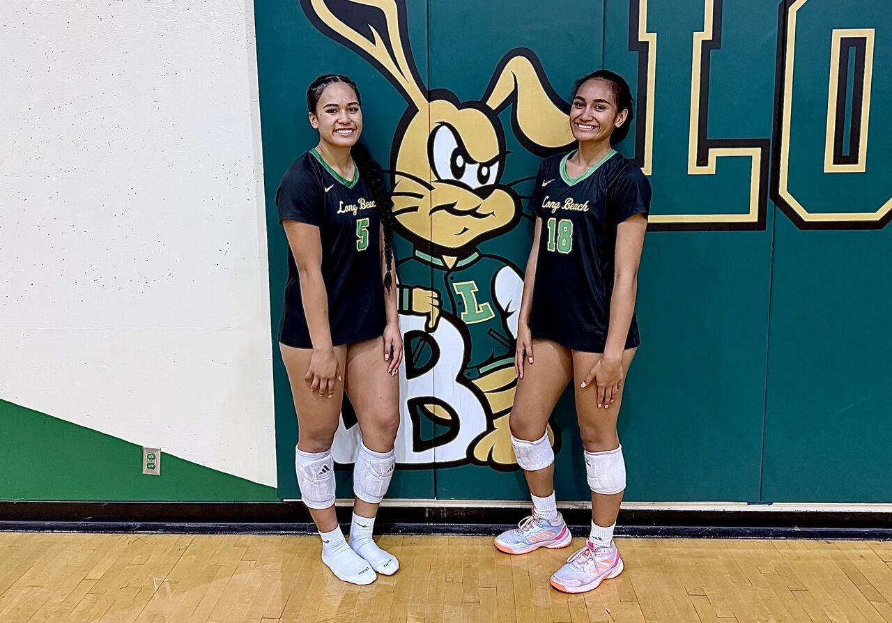 Sisters McKennah, left, and Ellie Iamaleava pose for a photo in the gym.