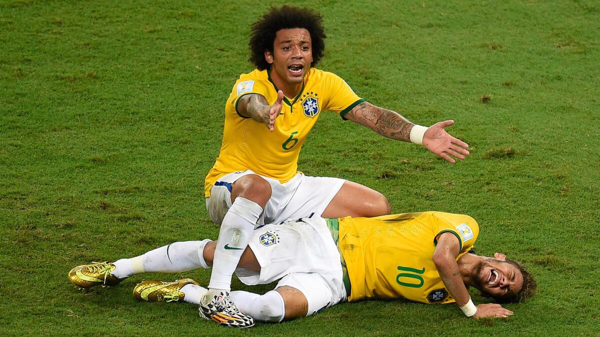 Brazil defender Marcelo, top, reacts after teammate Neymar is injured during the final minutes of the team's quarterfinal win over Colombia at the World Cup on Friday. FIFA is investigating the play to determine if any disciplinary measures are warranted.