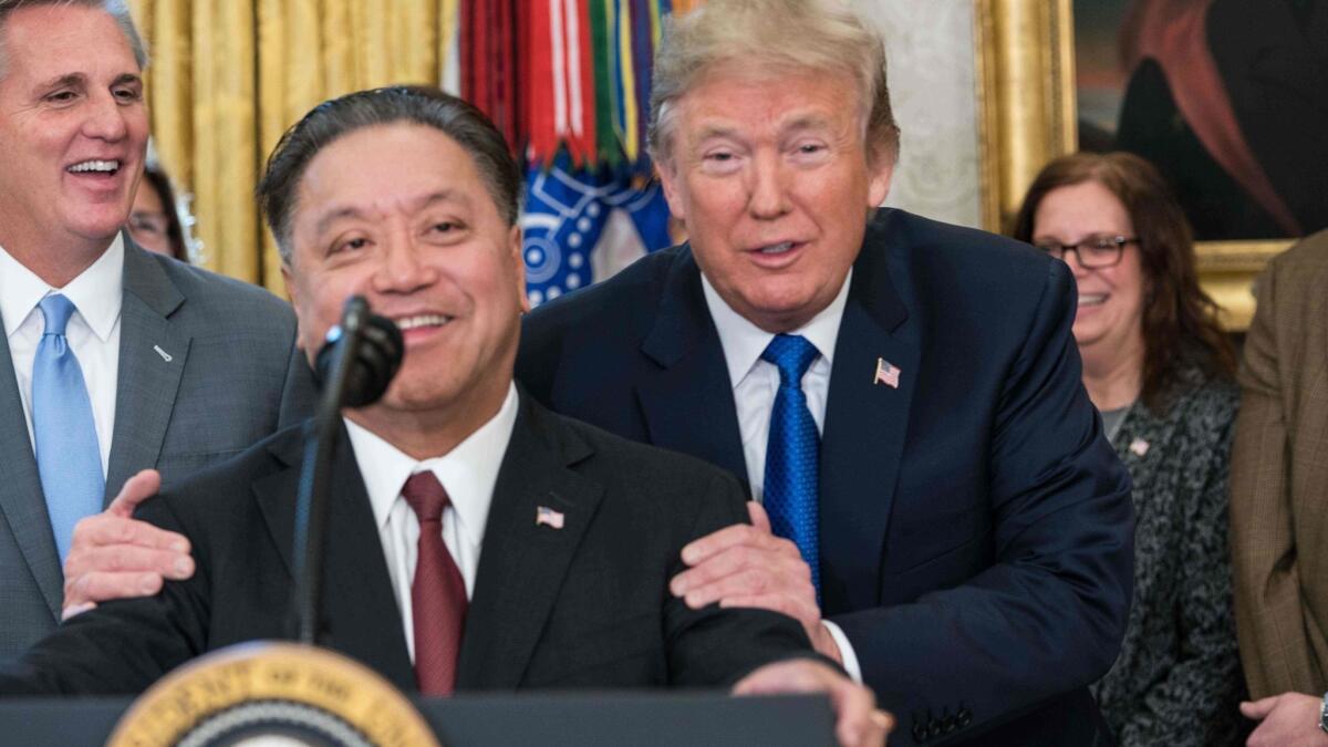 President Trump jokes with Hock Tan as the Broadcom CEO announces in February that his company would move back to the U.S. Trump would later quash Broadcom's buyout offer for Qualcomm over "national security" concerns.