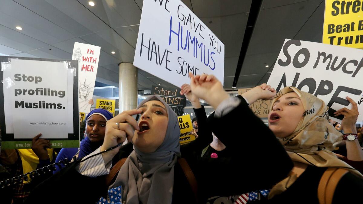 Women protest President Trump's travel ban at LAX last month.