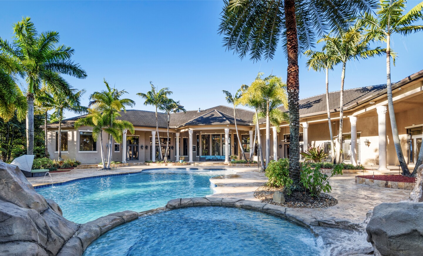 The 2.3-acre estate holds a main home, guesthouse and resort-style backyard with a swimming pool and spa.
