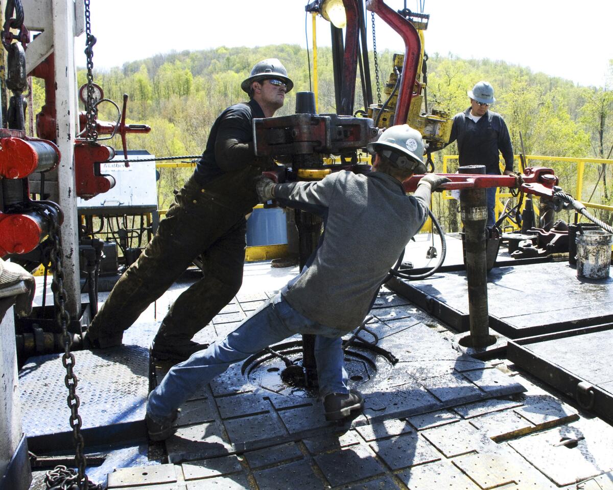 Workers toil at a natural gas well location. 