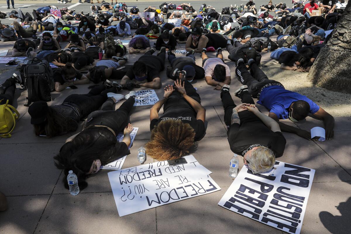 Protesters stage a sit-in demonstration at the Anaheim Civic Center