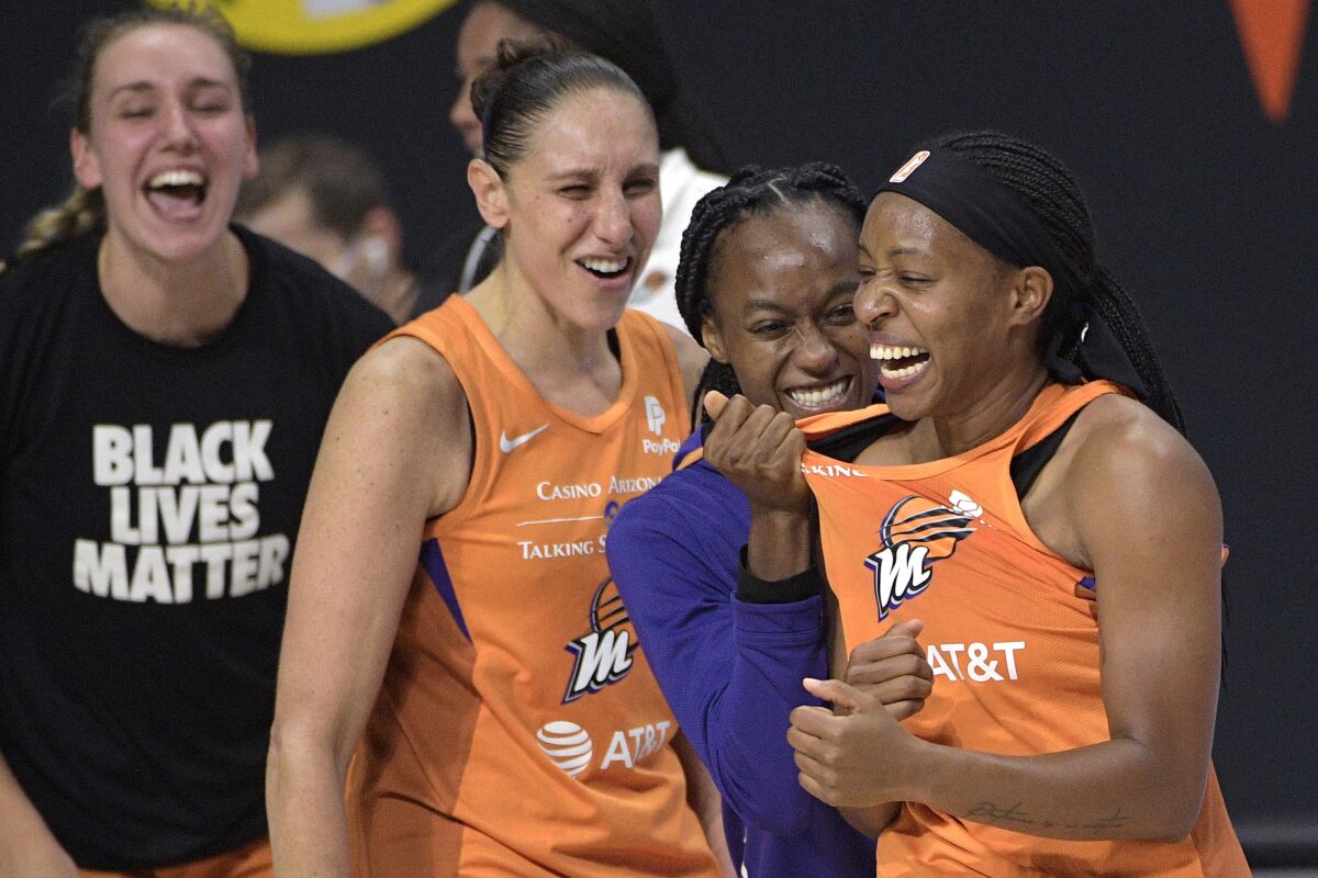Phoenix Mercury guard Shey Peddy, right, is congratulated by guard Shatori Walker-Kimbrough, second from right, guard Diana Taurasi and forward Alanna Smith, left, after Peddy scored the game-winning shot as time expired against the Washington Mystics during a WNBA basketball first-round playoff game Tuesday, Sept. 15, 2020, in Bradenton, Fla. (AP Photo/Phelan M. Ebenhack)