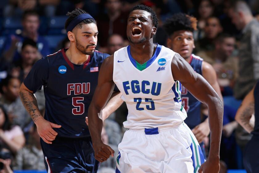 Florida Gulf Coast forward Marc Eddy Norelia reacts after a basket in the first half against Fairleigh Dickinson.