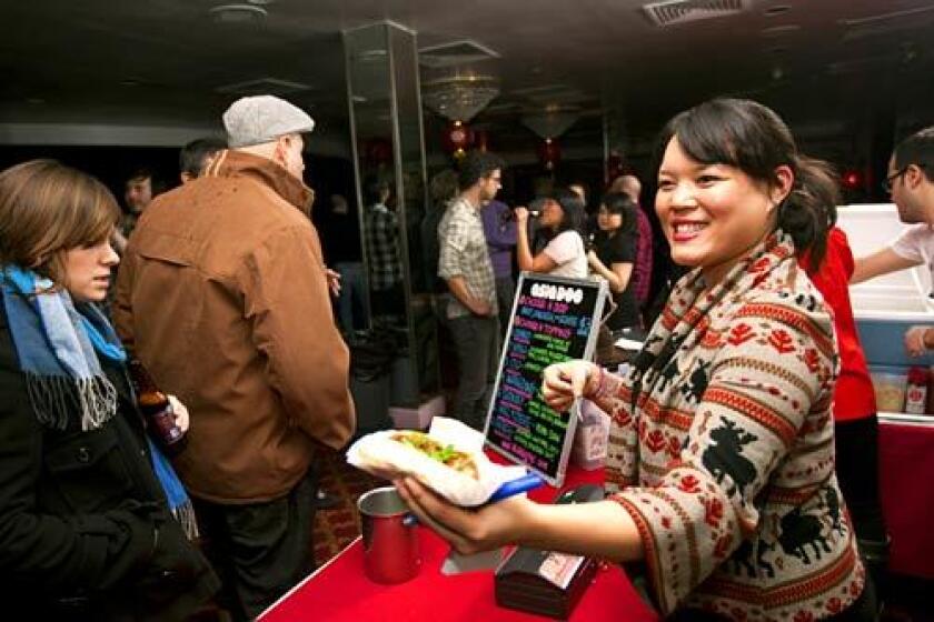 Melanie Campbell of AsiaDog prepares her pop-up restaurant's offerings at a New York party.