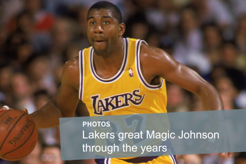 Lakers star Earvin "Magic" Johnson dribbles the ball during a game at the Forum in 1987. Widely considered one of the greatest players in NBA history, Johnson won five NBA titles with the Lakers.