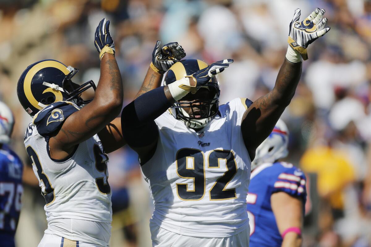 Rams defensive tackle Cam Thomas, right, celebrates with defensive end Ethan Westbrooks after he blocked an extra-point attempt by the Buffalo Bills on Sunday.
